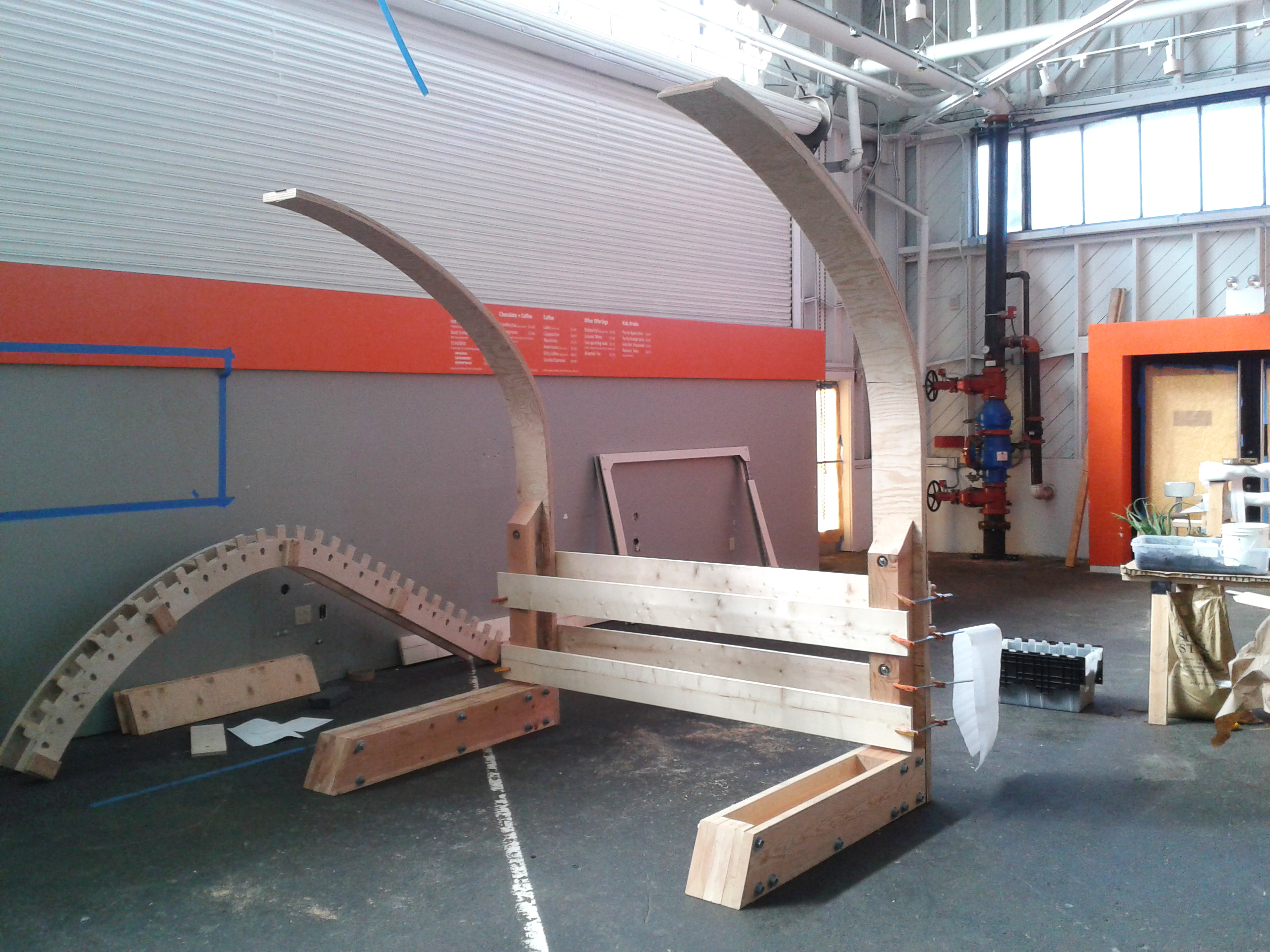 Full-scale curved wooden structure and seating under development in the Exploratorium studio