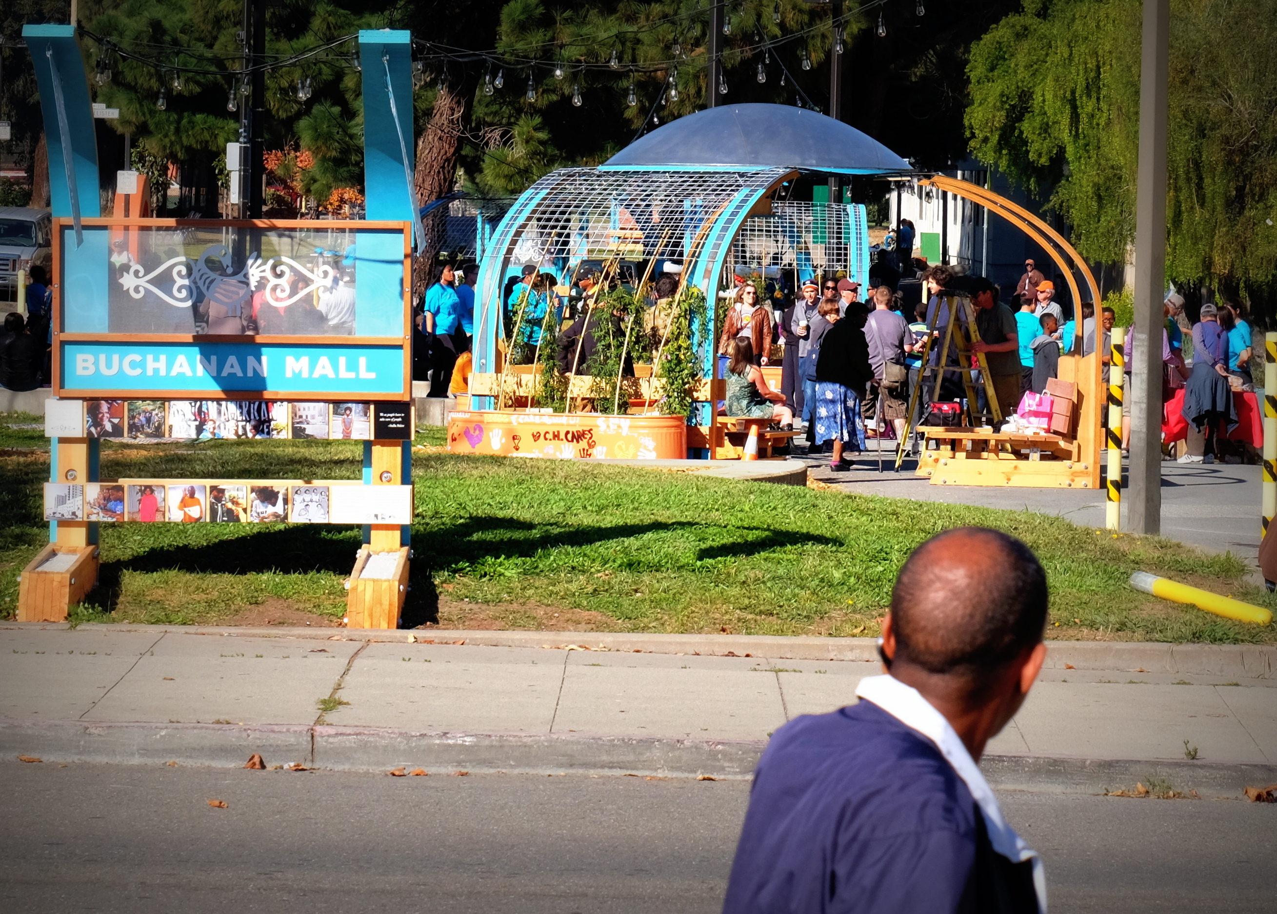 Buchanan Mall gateway and colorful installation with people gathering in the park