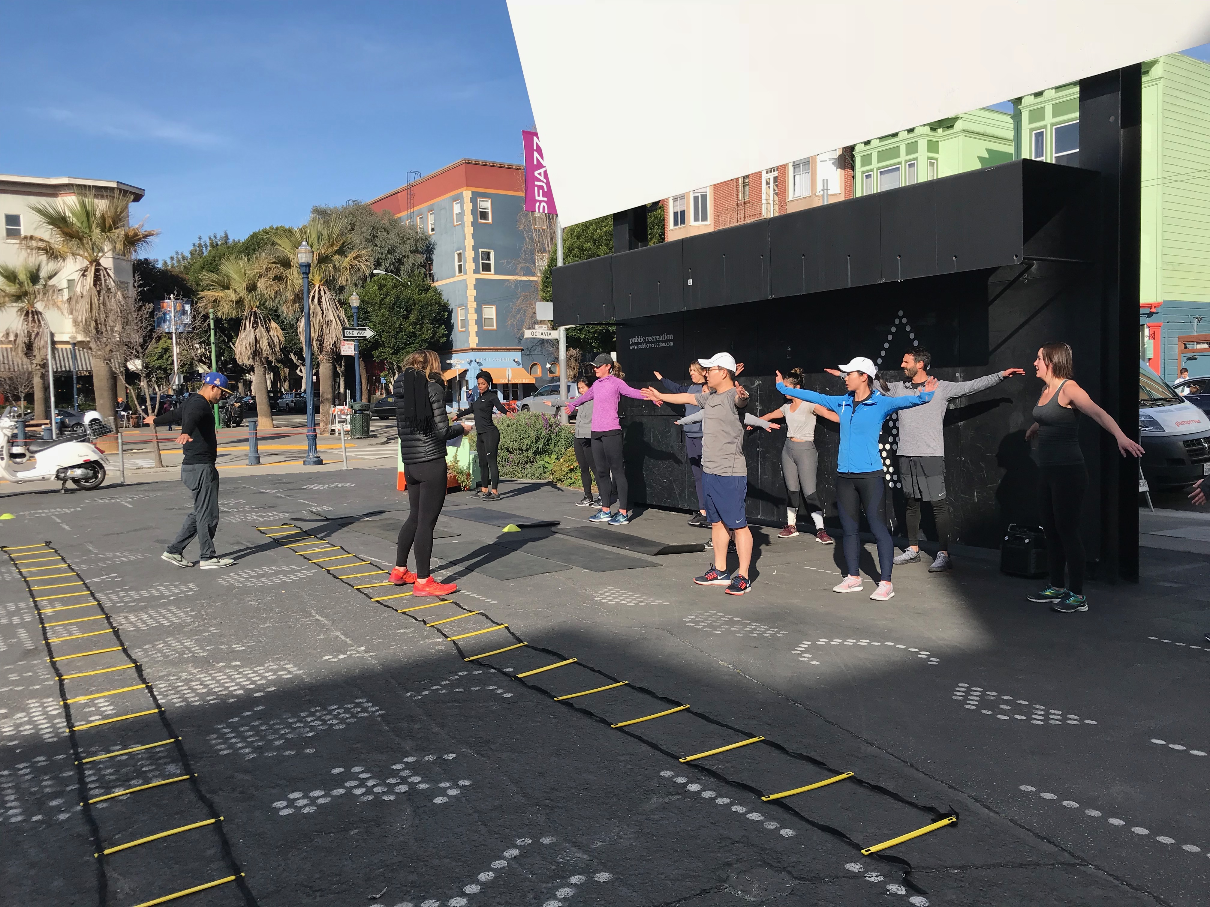 People taking part in a guided outdoor group exercise at the Public Recreation site