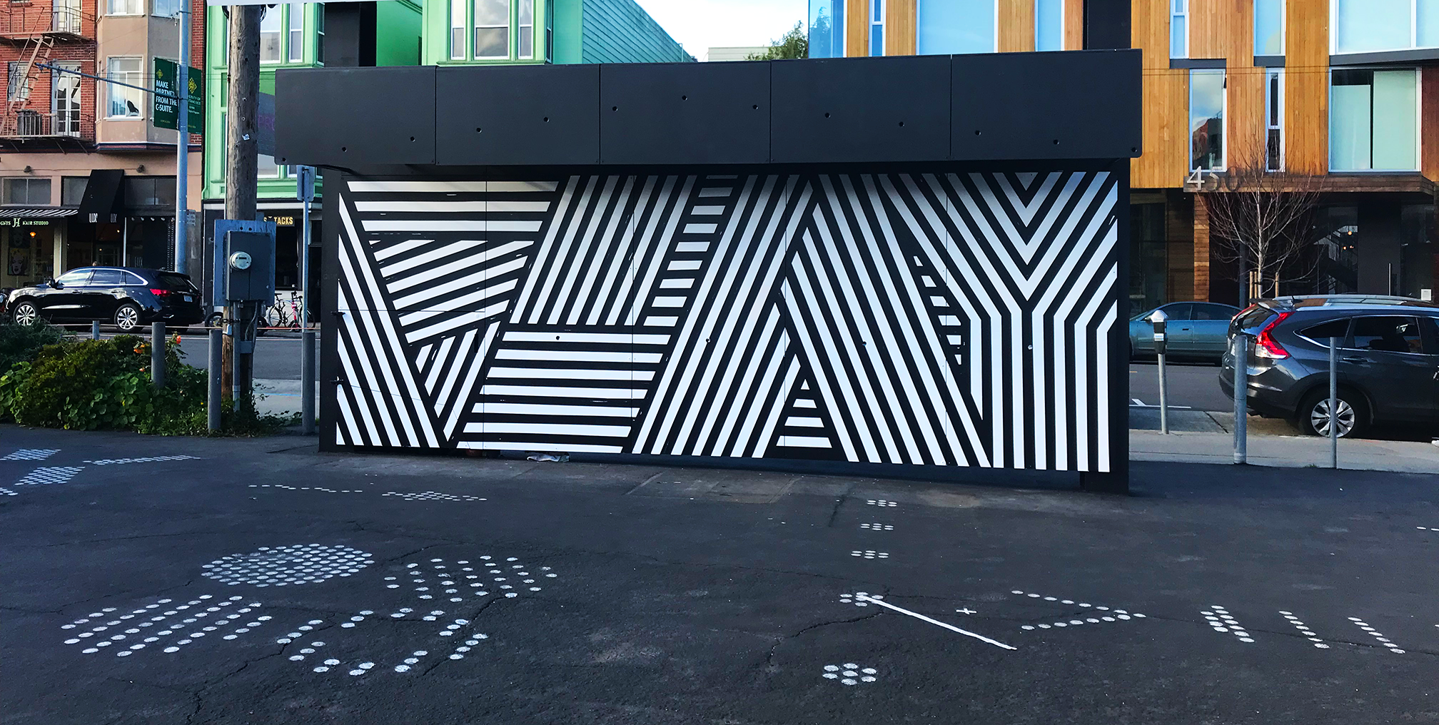 Outdoor site with a patterned storage wall and exercise markings on the ground